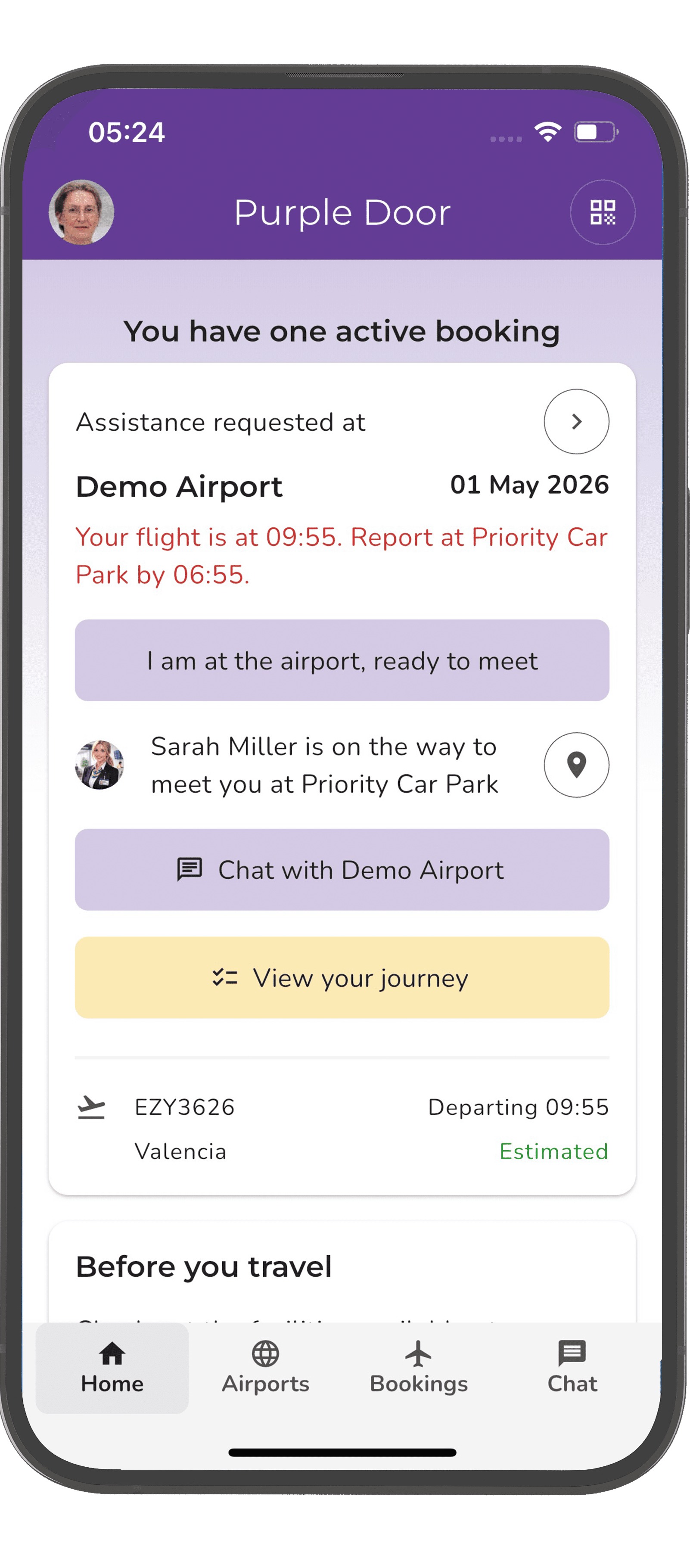 Home page of the Purple Door application shown on an iPhone. The user has one active booking and will be assisted by Mary Lewis at the Coach Station.
